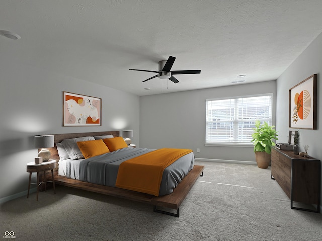 carpeted bedroom featuring a ceiling fan, a textured ceiling, and baseboards