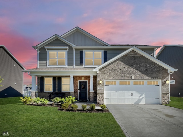 craftsman-style home featuring stone siding, a lawn, board and batten siding, and concrete driveway