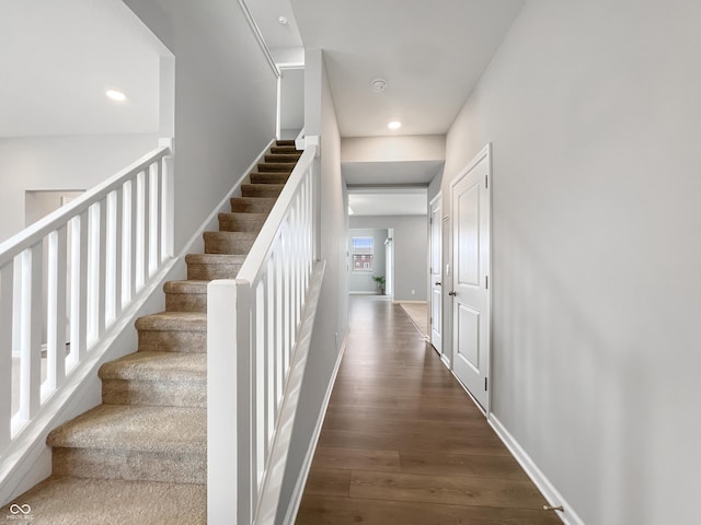 stairs featuring recessed lighting, wood finished floors, and baseboards