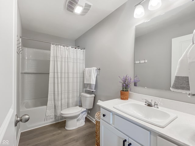 full bath with visible vents, toilet, wood finished floors, shower / bath combination with curtain, and vanity