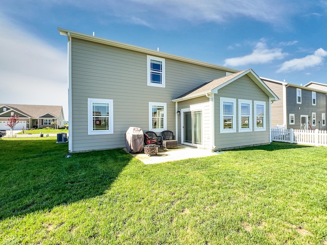 back of property featuring a yard, a patio, and fence