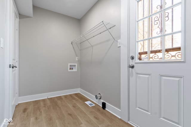 laundry area featuring visible vents, light wood-style floors, baseboards, hookup for a washing machine, and laundry area