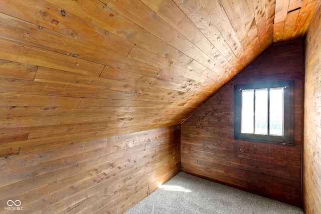 bonus room featuring lofted ceiling, wood ceiling, wood walls, and carpet floors