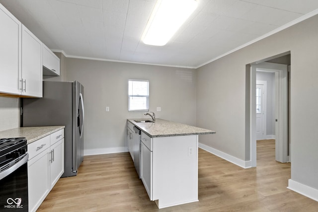 kitchen with light wood finished floors, a peninsula, appliances with stainless steel finishes, white cabinetry, and crown molding