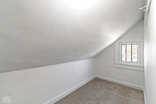 bonus room with vaulted ceiling, carpet flooring, and baseboards