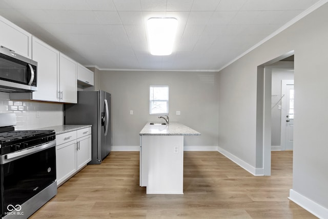 kitchen featuring white cabinets, stainless steel appliances, light wood-style flooring, and a sink