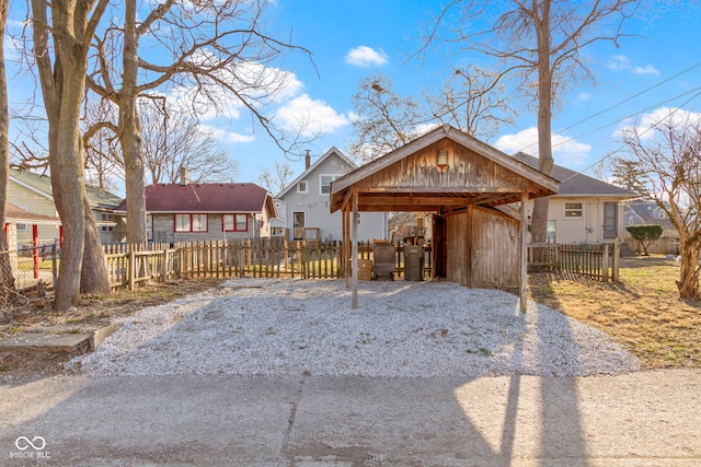 exterior space featuring a fenced front yard and a detached carport