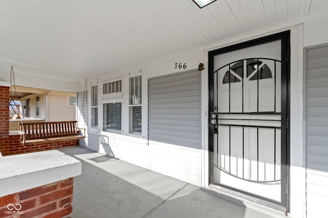 entrance to property featuring a porch