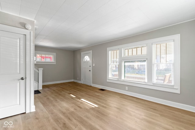 entryway featuring visible vents, baseboards, and light wood-style floors