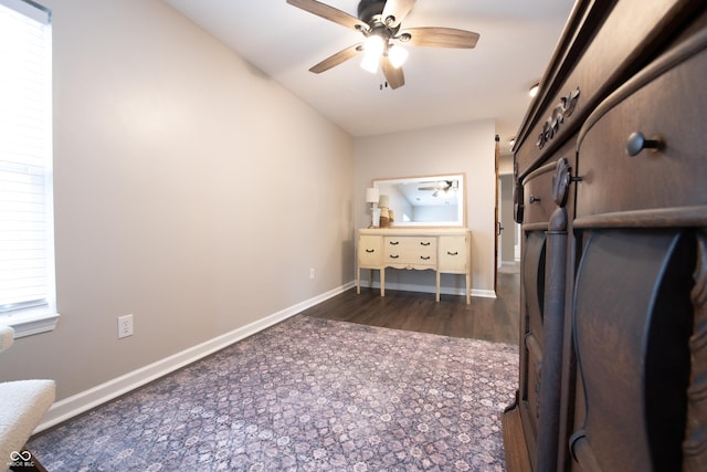 interior space featuring dark wood-style floors, baseboards, and a ceiling fan