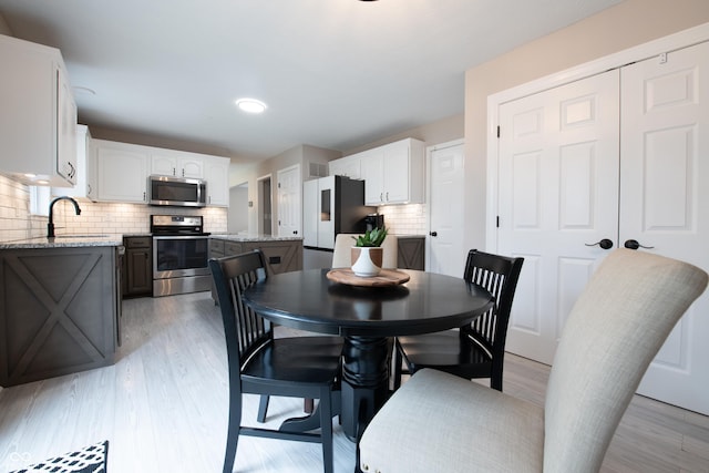 dining room with light wood-style flooring