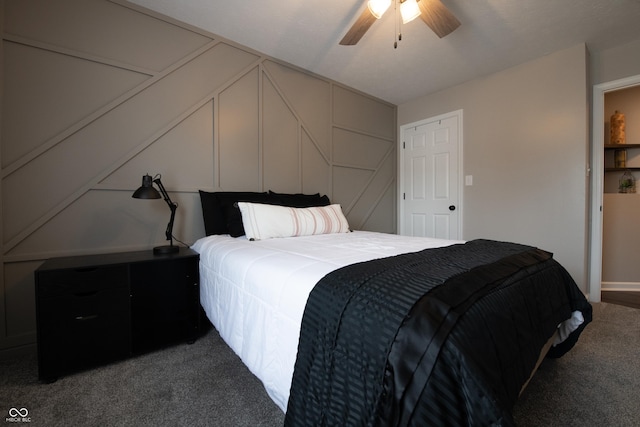 carpeted bedroom featuring ceiling fan, lofted ceiling, and a decorative wall