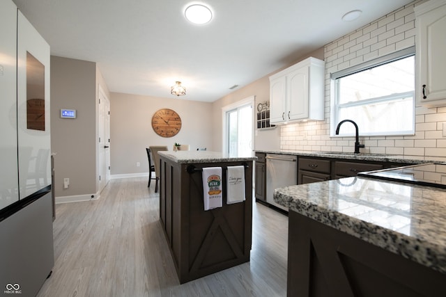 kitchen with stainless steel appliances, plenty of natural light, and backsplash