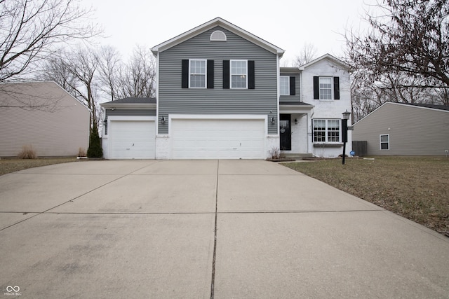 traditional-style home with cooling unit, driveway, and an attached garage