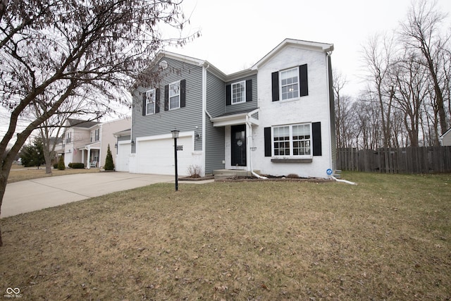 traditional-style home featuring a garage, concrete driveway, fence, a front lawn, and brick siding