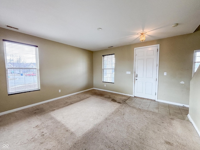 interior space with visible vents, baseboards, and carpet floors