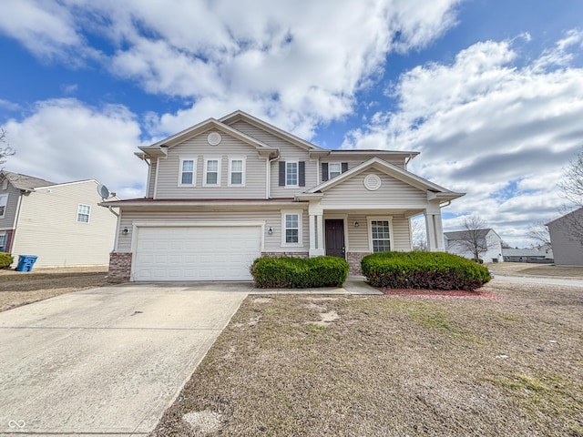 traditional home featuring concrete driveway, an attached garage, and brick siding