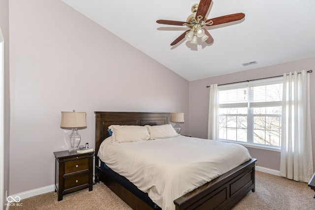 bedroom with light colored carpet, visible vents, a ceiling fan, vaulted ceiling, and baseboards