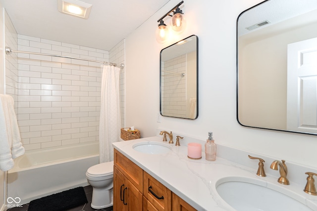 bathroom with visible vents, a sink, toilet, and shower / bath combo with shower curtain