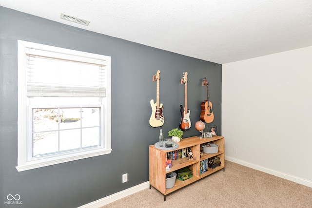 playroom with carpet floors, visible vents, and baseboards