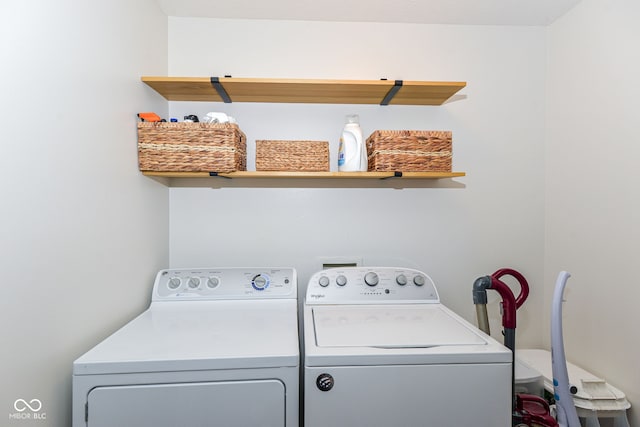 clothes washing area with washing machine and dryer and laundry area