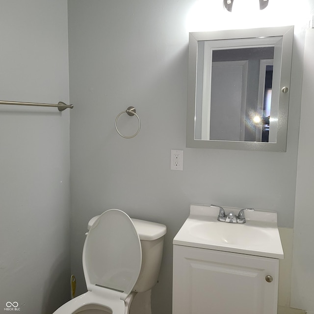 half bath with vanity and toilet