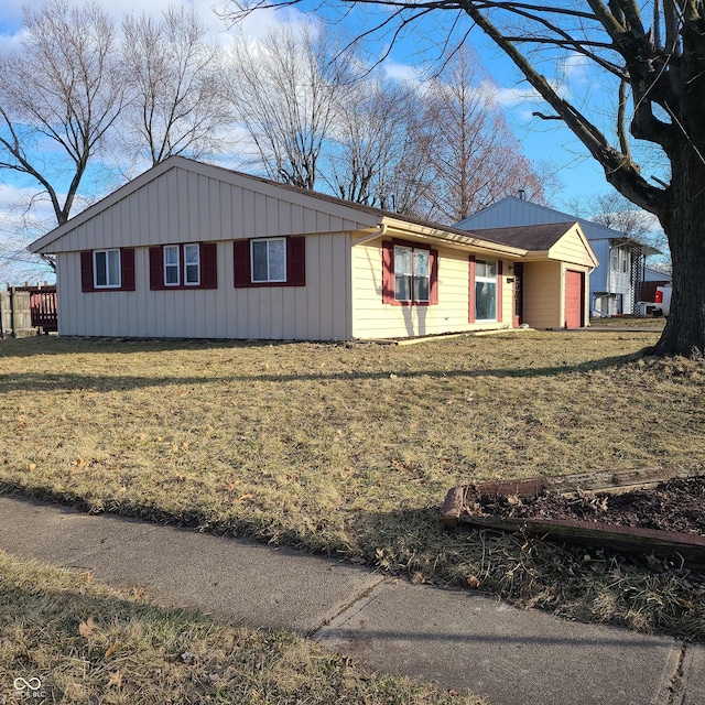 view of front facade featuring board and batten siding and a front yard