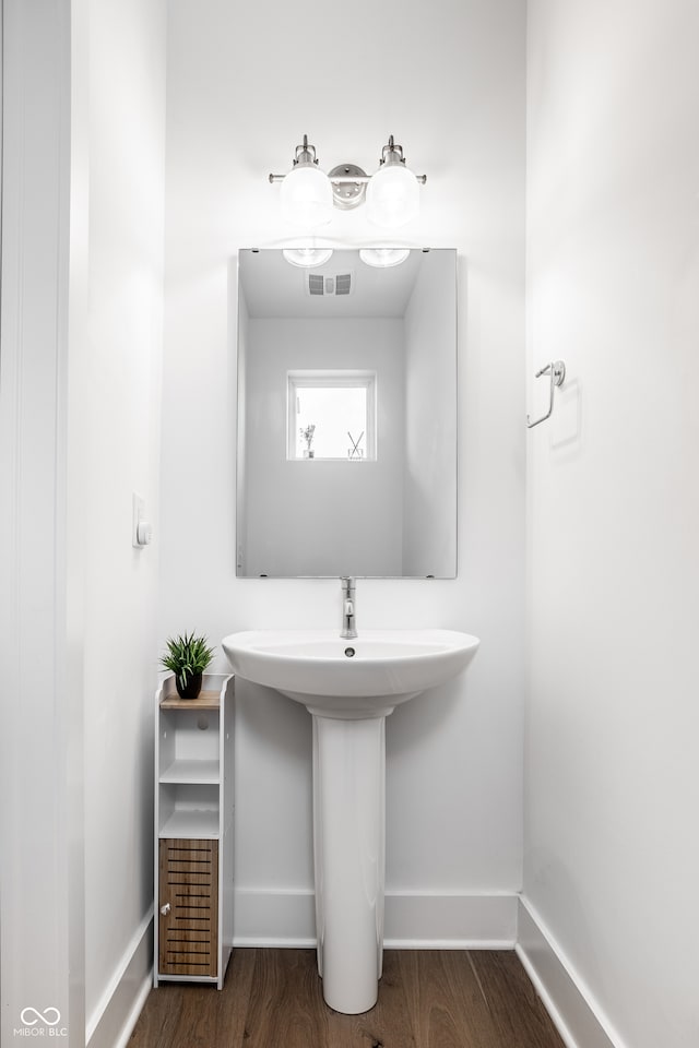 bathroom featuring visible vents, baseboards, and wood finished floors