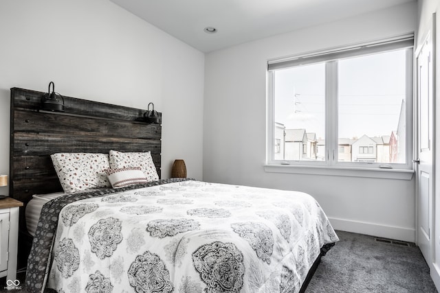 carpeted bedroom featuring visible vents and baseboards