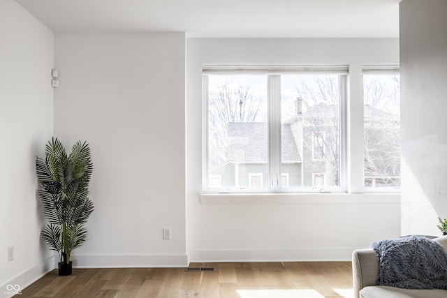 sitting room featuring visible vents, baseboards, and wood finished floors