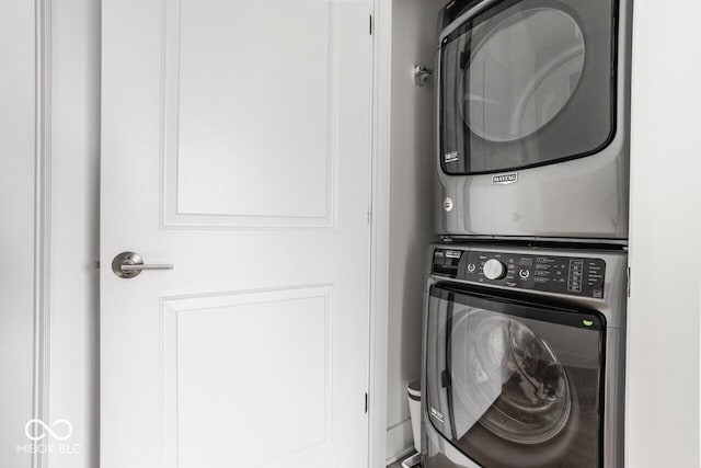 laundry area with stacked washer / drying machine and laundry area