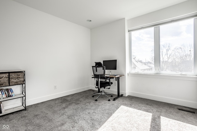 carpeted home office with visible vents and baseboards