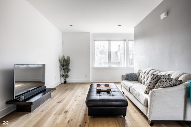 living room featuring light wood finished floors and baseboards