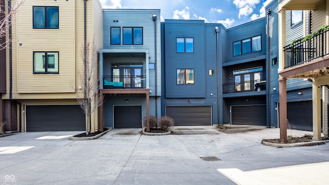 rear view of property featuring a garage and driveway