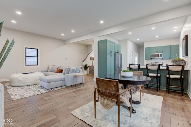 dining room featuring recessed lighting, light wood-type flooring, and baseboards