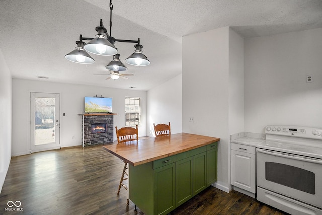 kitchen featuring a glass covered fireplace, green cabinets, wooden counters, white range with electric stovetop, and dark wood finished floors