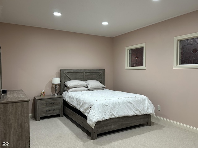 bedroom featuring light carpet, baseboards, and recessed lighting