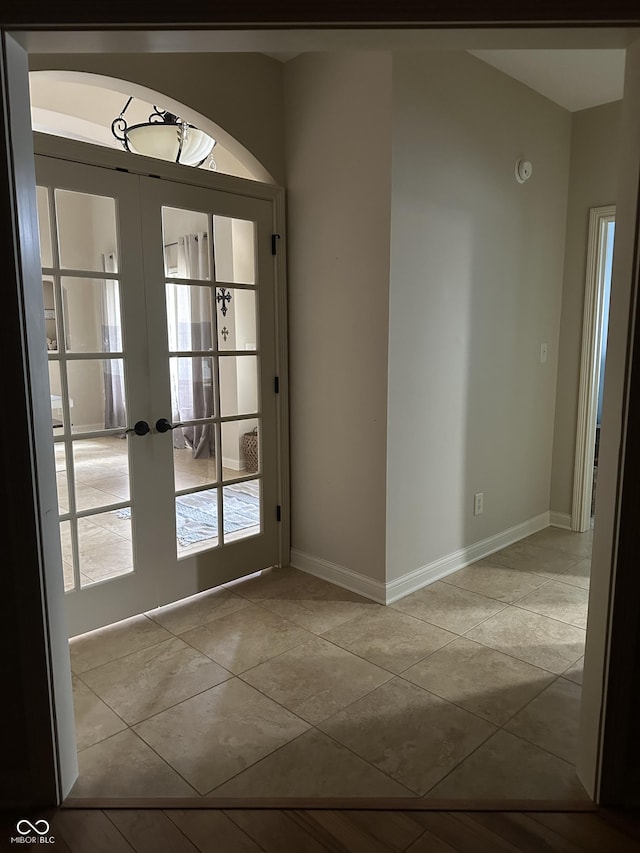 entryway featuring tile patterned floors, baseboards, and french doors