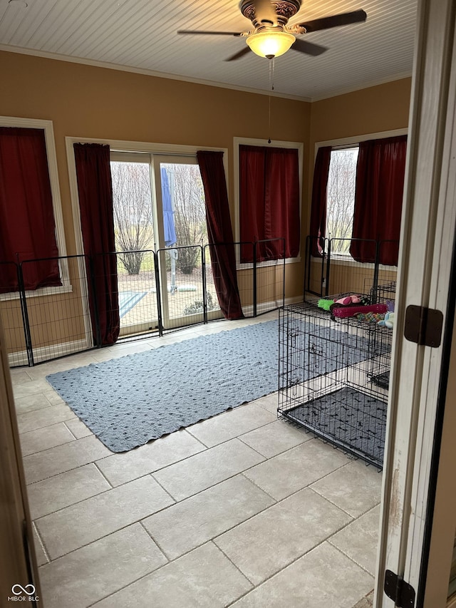 unfurnished room with ornamental molding and a ceiling fan