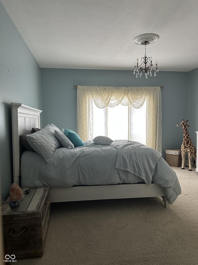 bedroom with carpet flooring and an inviting chandelier