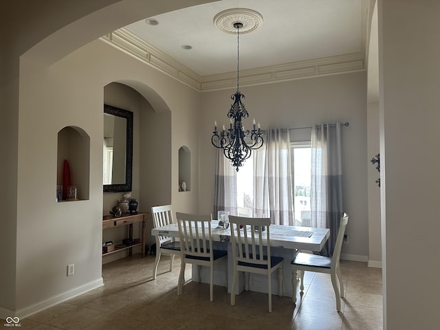 tiled dining room featuring baseboards, ornamental molding, and a chandelier