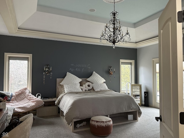 bedroom with carpet flooring, a raised ceiling, and an inviting chandelier