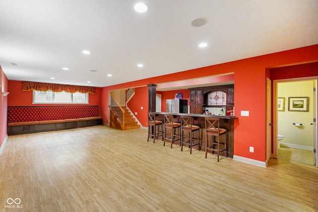 286 S Woodridge Dr, Pittsboro, IN 46167 - indoor bar with light wood finished floors, baseboards, an accent wall, stairs, and recessed lighting