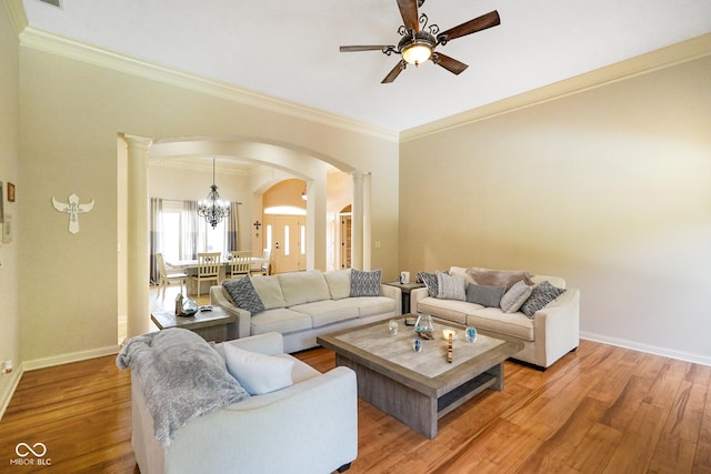 286 S Woodridge Dr, Pittsboro, IN 46167 - living area featuring decorative columns, arched walkways, ornamental molding, a ceiling fan, and light wood-type flooring