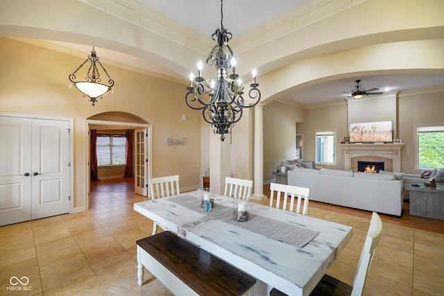 286 S Woodridge Dr, Pittsboro, IN 46167 - dining space featuring arched walkways, a ceiling fan, light tile patterned floors, ornamental molding, and a tiled fireplace