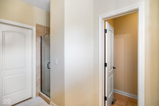 286 S Woodridge Dr, Pittsboro, IN 46167 - bathroom featuring a stall shower, baseboards, and tile patterned floors