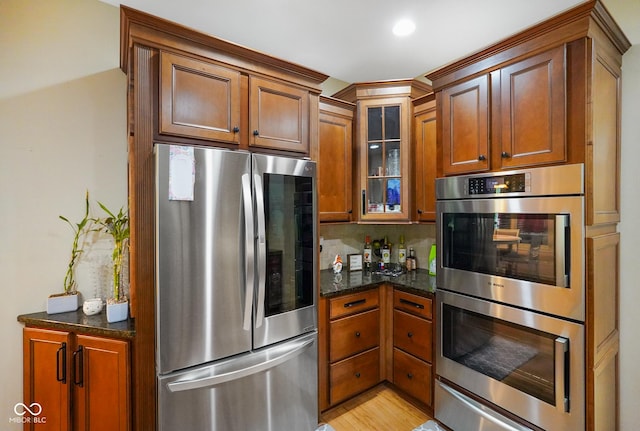 286 S Woodridge Dr, Pittsboro, IN 46167 - kitchen with stainless steel appliances, glass insert cabinets, and brown cabinets