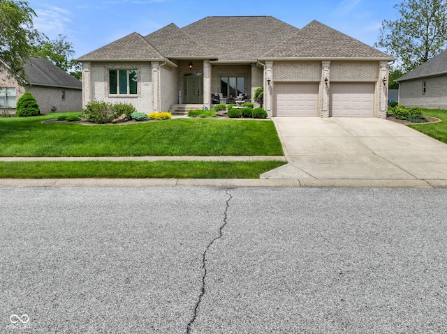286 S Woodridge Dr, Pittsboro, IN 46167 - view of front of home featuring brick siding, a garage, a front lawn, concrete driveway, and roof with shingles