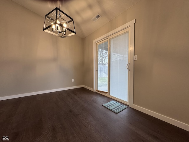 interior space with dark wood-style floors, vaulted ceiling, visible vents, and baseboards