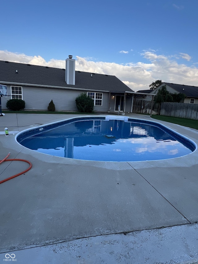 view of swimming pool featuring fence and a fenced in pool